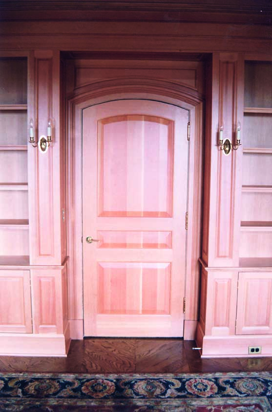 A beautifully carpentered door, with bespoke wooden frame and shelves.