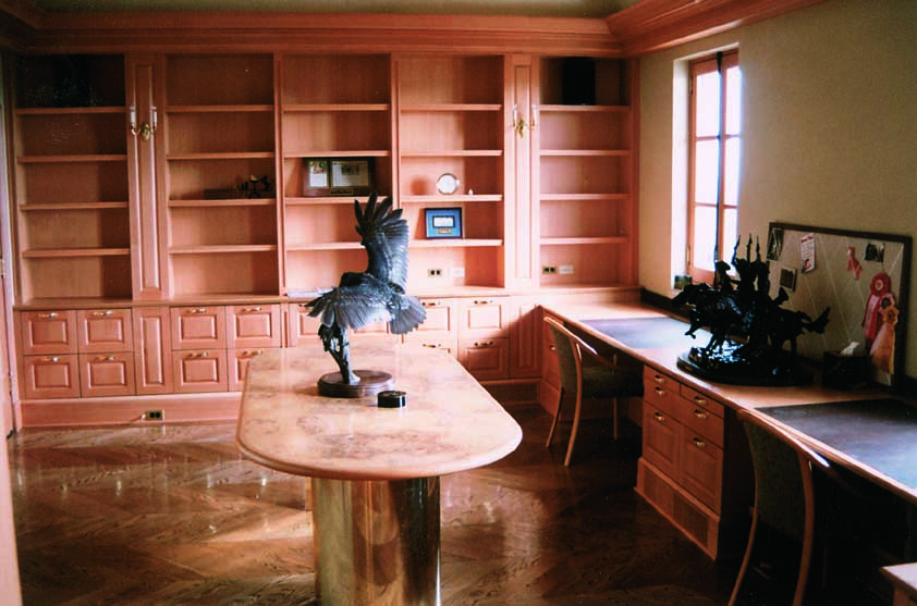 A very high-end home interior with elaborate wooden bookshelves.