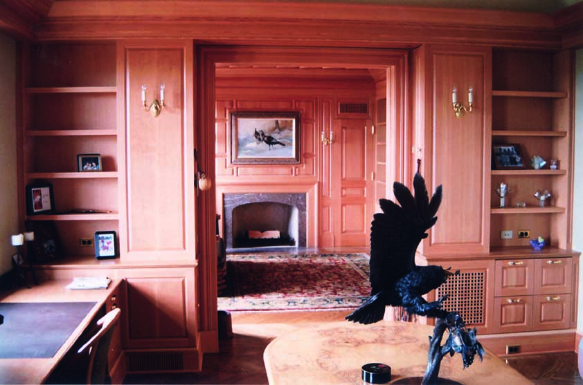 A living room with ornate woodwork across the walls.